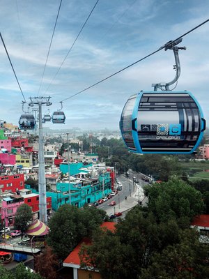 Photo of the ropeway in Mexico City, which gondolas above the rooftops and connects the workers' cuautepec district with the city's metro network.