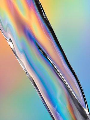 Photo of water in motion. The water pours from the upper left corner of the image to the lower right. It is a compact body that shimmers and fluoresces in different colors. The background is a gradient of colors.