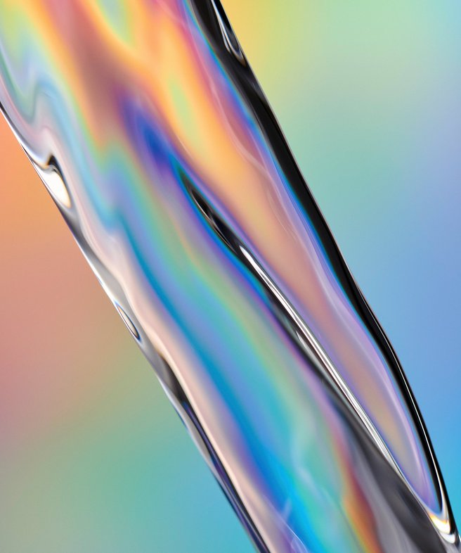 Photo of water in motion. The water pours from the upper left corner of the image to the lower right. It is a compact body that shimmers and fluoresces in different colors. The background is a gradient of colors.