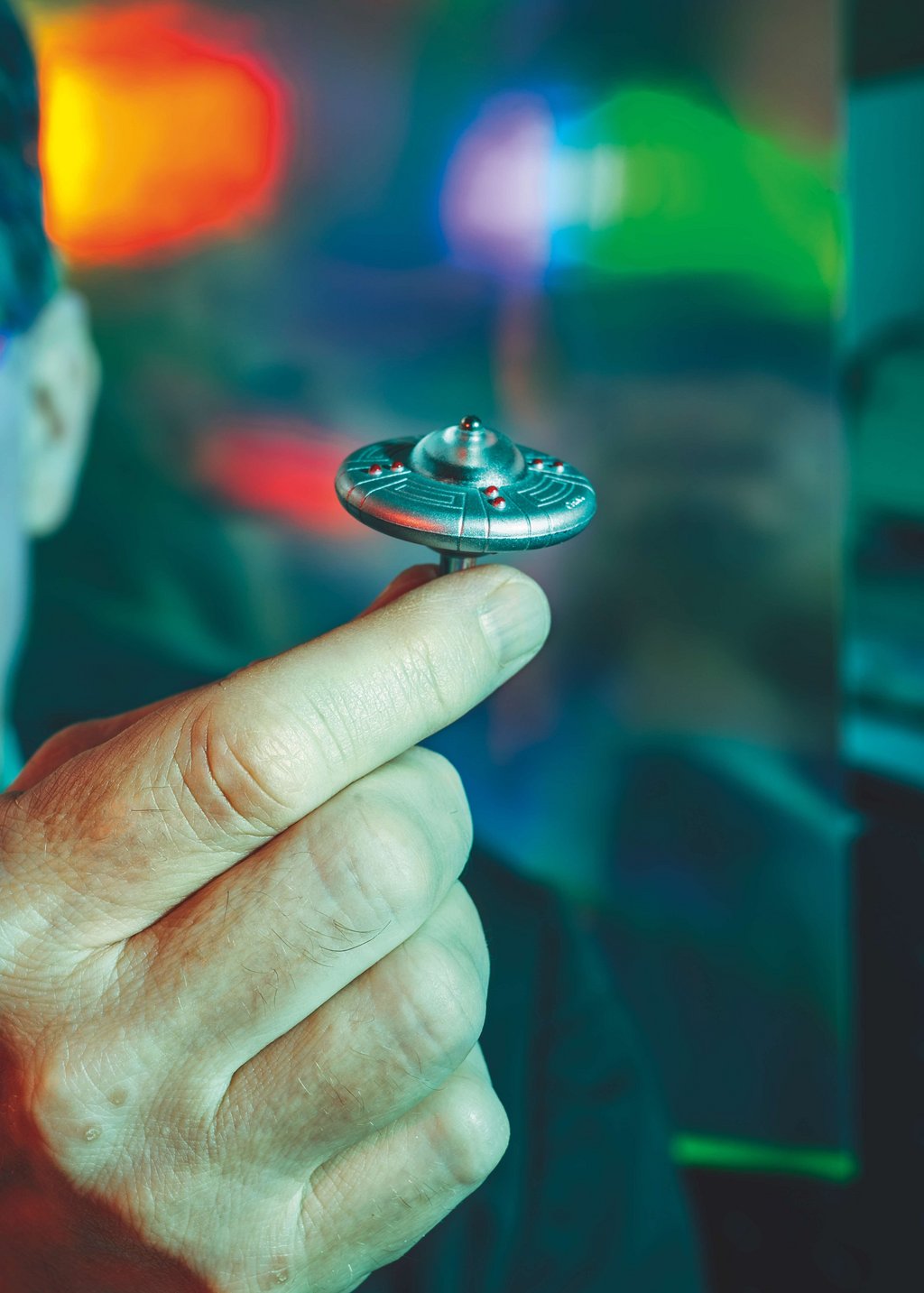 Modell eines kleinen UFOs wird von einer Hand gehalten.